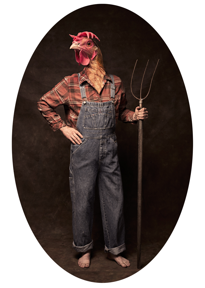 A farmer holding a pitching fork with a chicken head